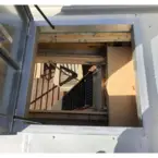 Roof access hatch with stairs providing secure and easy rooftop access.